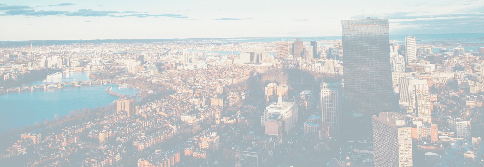A faded out photo of Boston with sky scrapers in the foreground and water in the background.